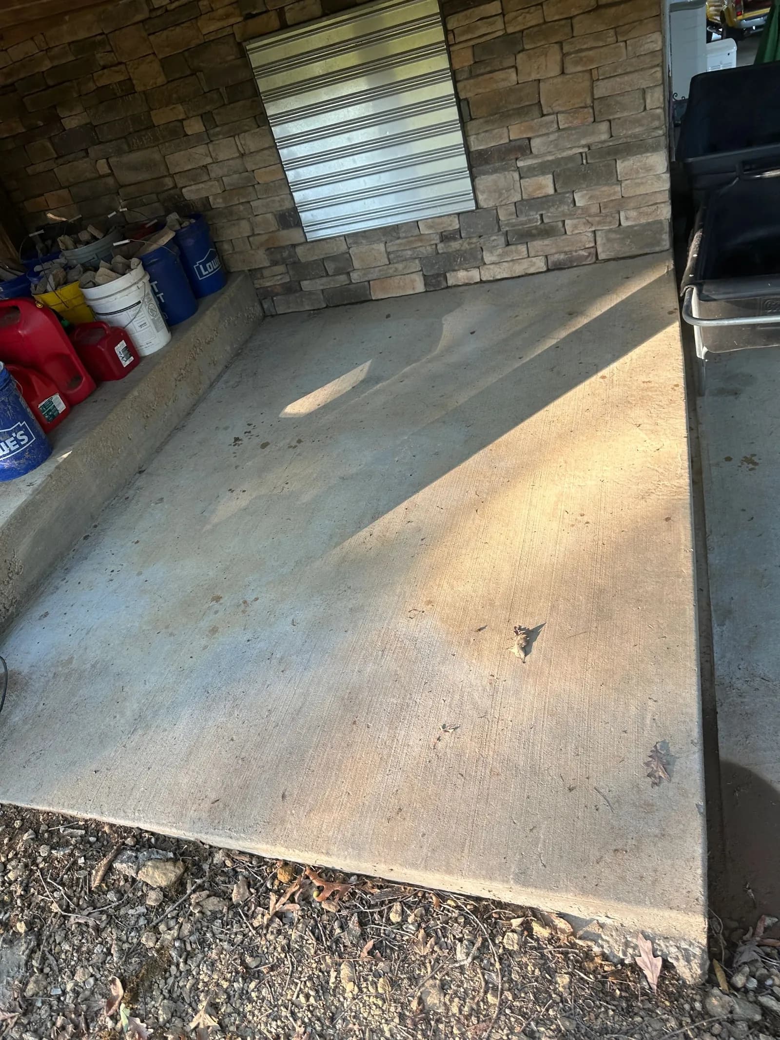The same patio after pressure washing, clean concrete throughout
