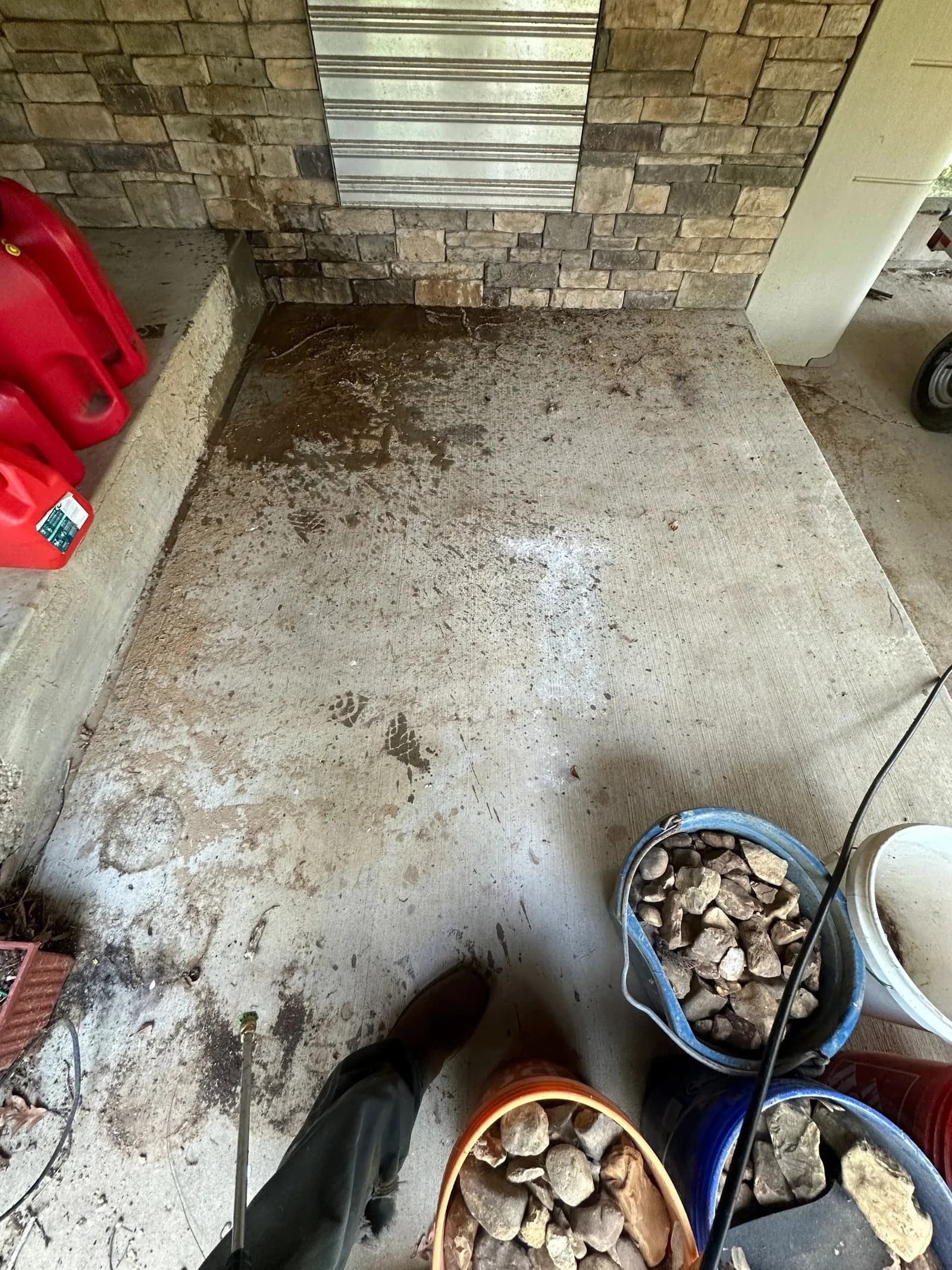 Covered concrete patio stained with dirt and debris