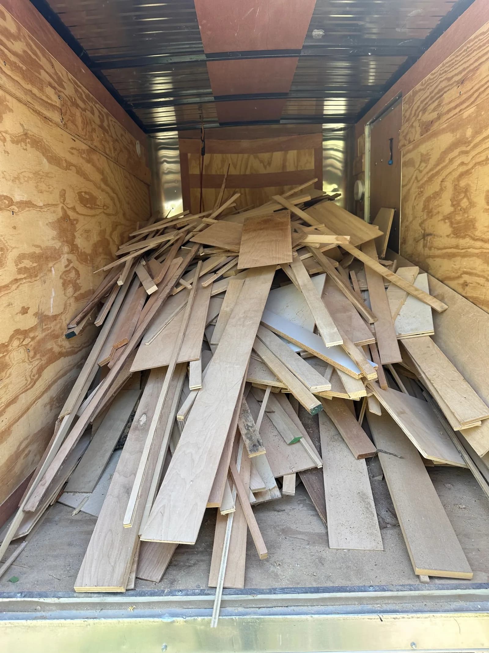 Trailer loaded with scrap lumber for the dump