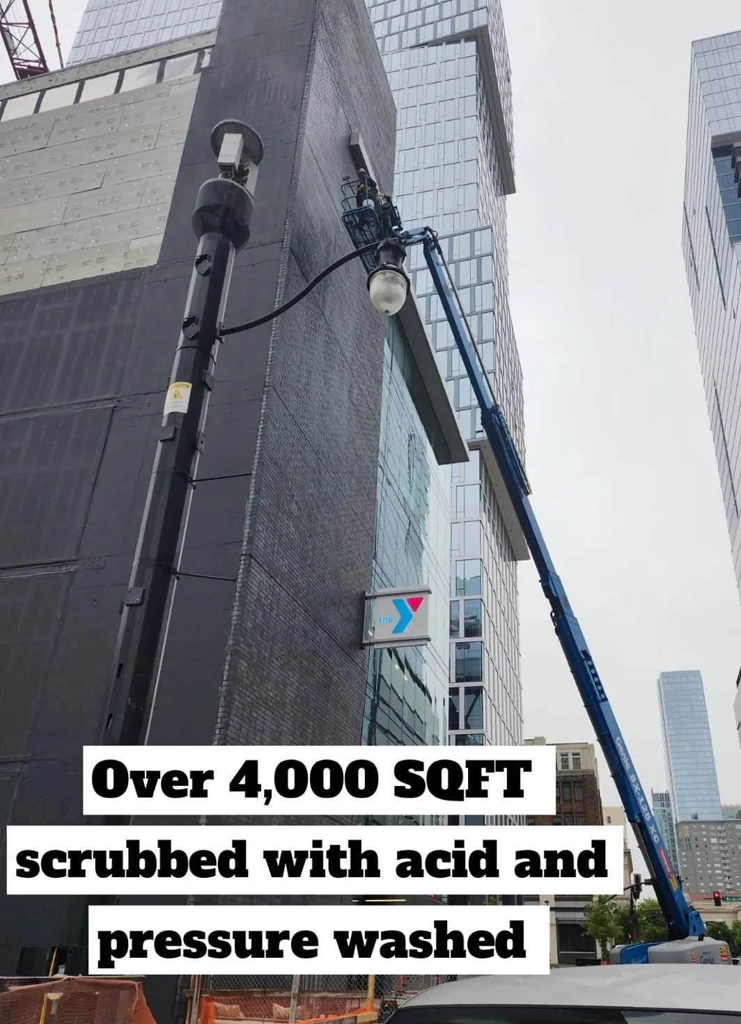 Lift at height against the wall, over 4,000 square feet scrubbed with acid and pressure washed