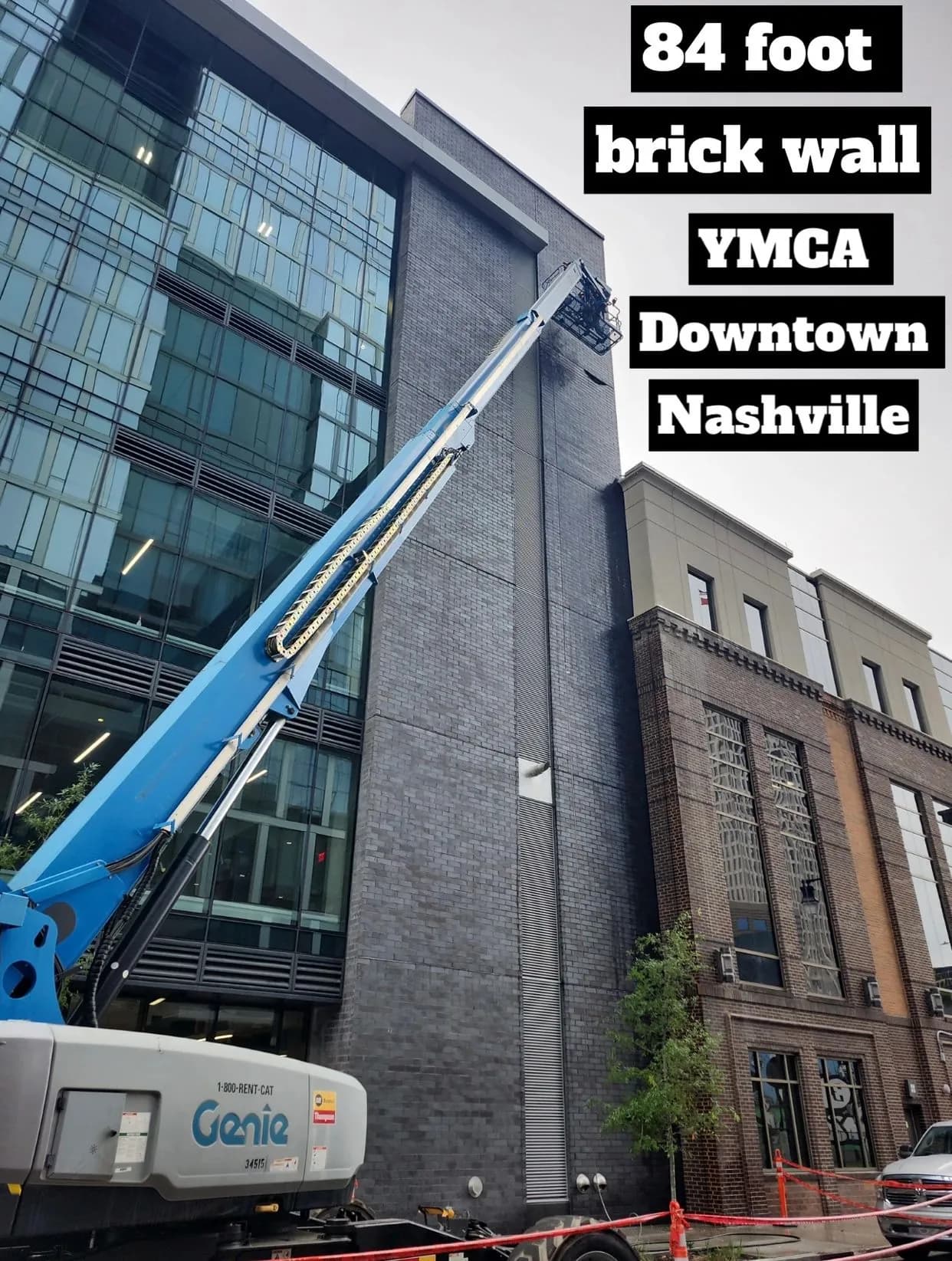 Boom lift extended against the brick wall