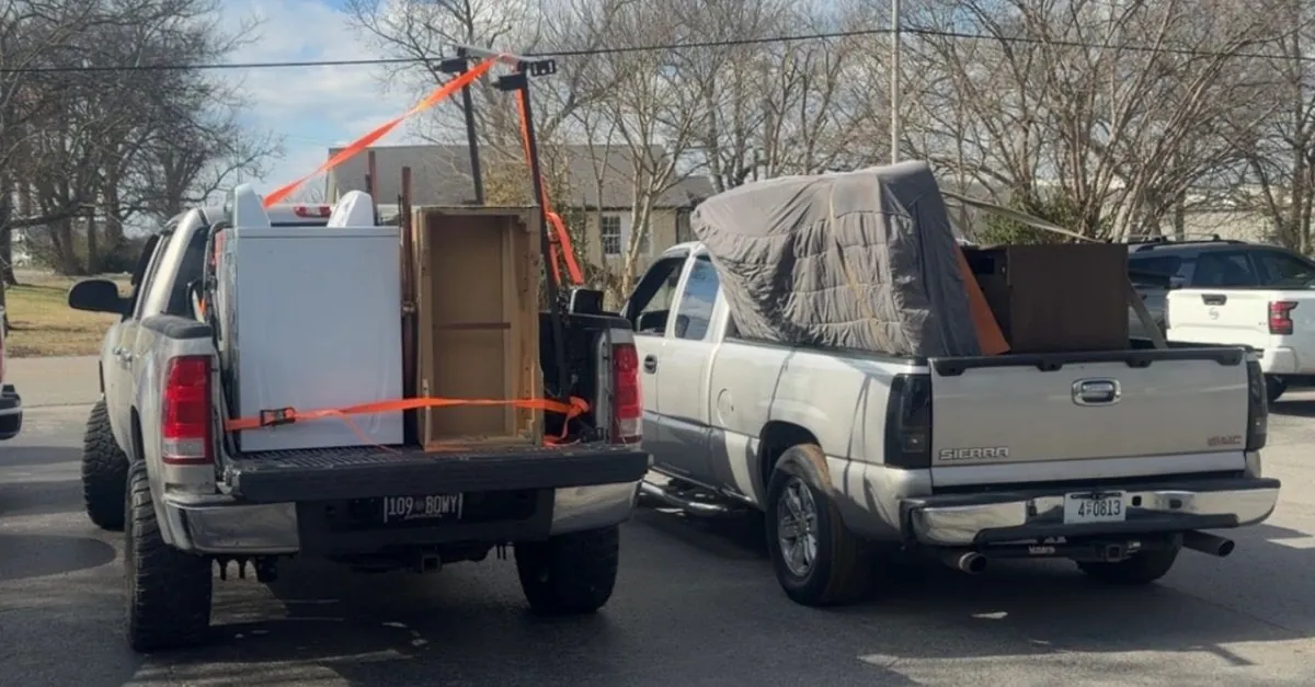 Household move in progress — packed boxes, loaded trailer and cleared rooms (9 of 10)