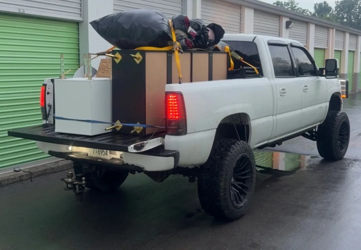 Household move in progress — packed boxes, loaded trailer and cleared rooms (2 of 10)