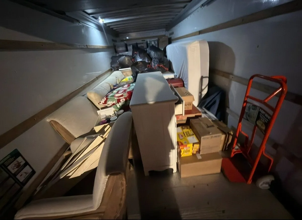 Household move in progress — packed boxes, loaded trailer and cleared rooms (5 of 10)