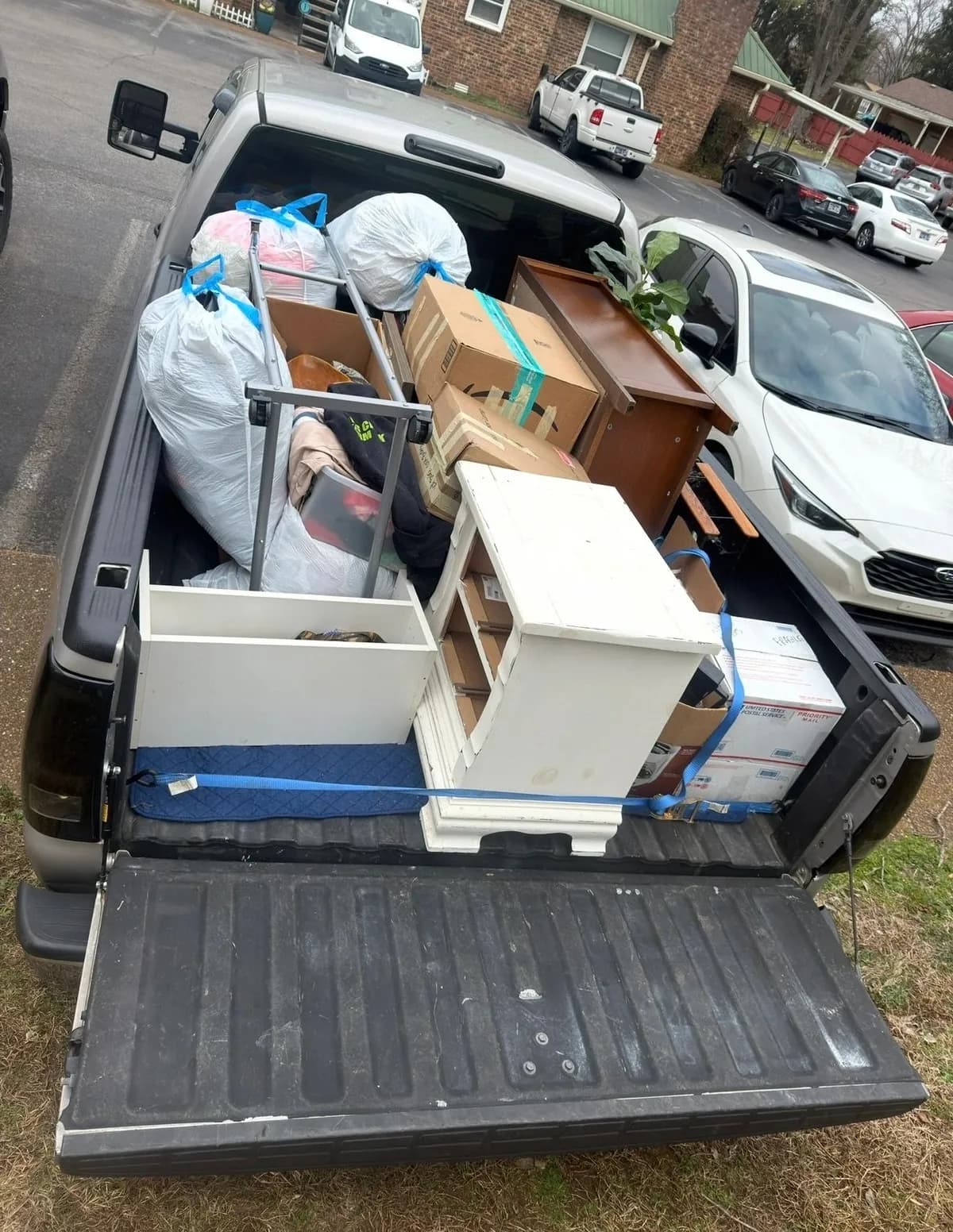 Household move in progress — packed boxes, loaded trailer and cleared rooms (6 of 10)
