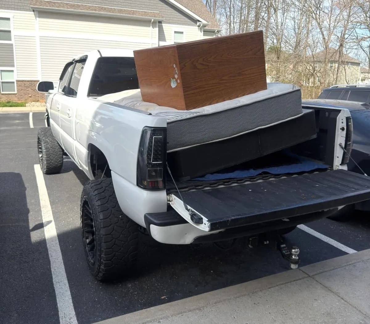 Household move in progress — packed boxes, loaded trailer and cleared rooms (3 of 10)