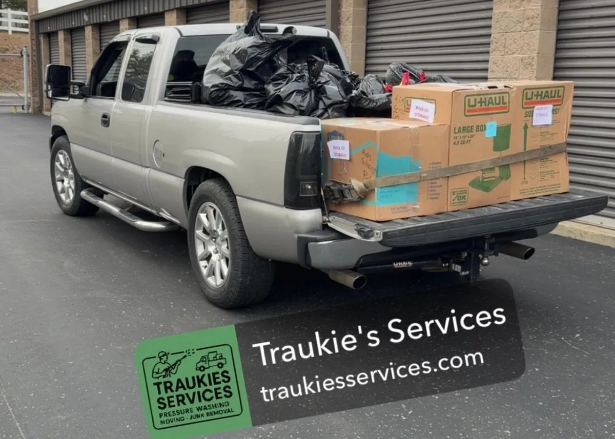 Household move in progress — packed boxes, loaded trailer and cleared rooms (4 of 10)