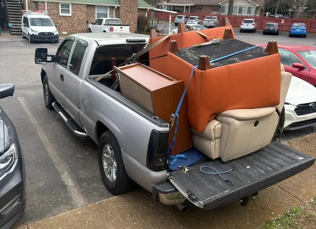 Household move in progress — packed boxes, loaded trailer and cleared rooms (7 of 10)