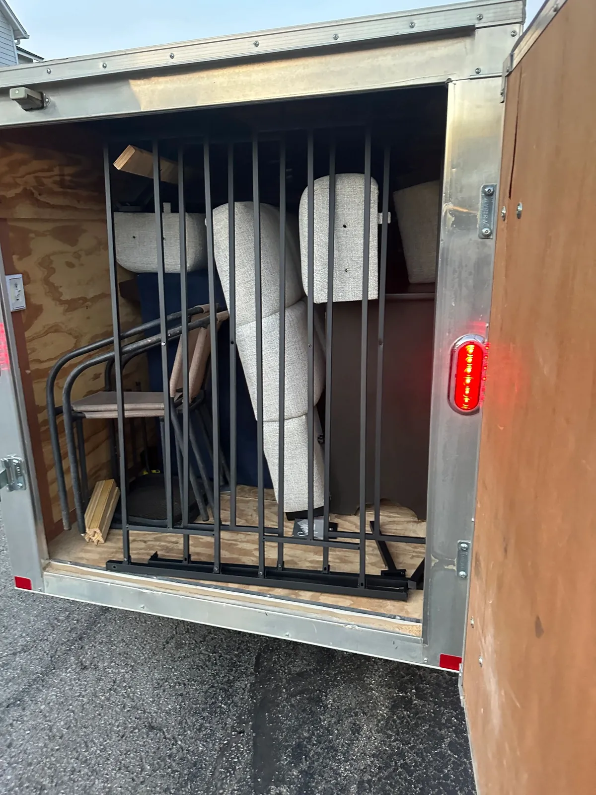 Enclosed trailer loaded with furniture and boxes